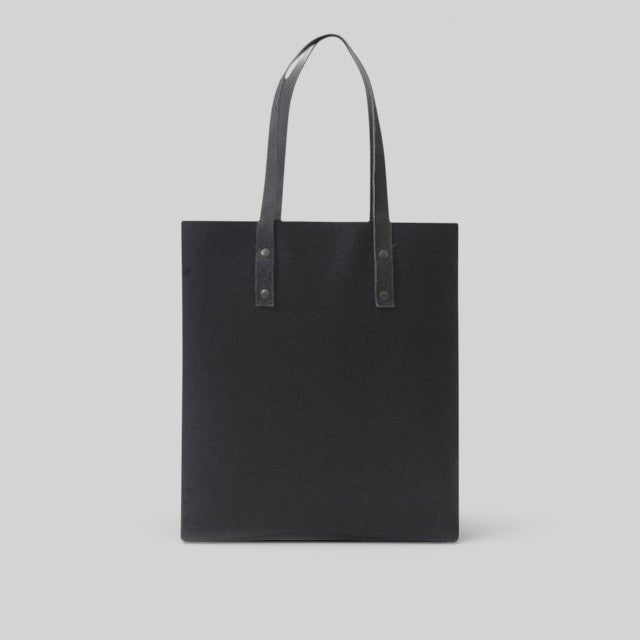 Baabuk Blacknose tote bag in black wool with leather handles, featuring a minimalist design and reversible interior.