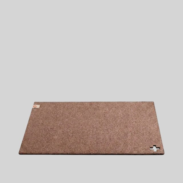 Baabuk brown felted wool table mat with a small Swiss cross cutout detail, handmade from natural New Zealand wool.