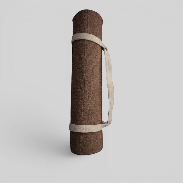 Baabuk brown felted wool yoga mat rolled up with a beige cotton carrying strap against a light grey background.