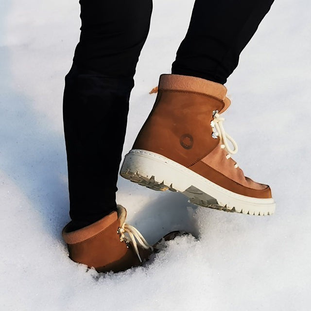 Baabuk Ice Wooler boots in Sand Rose nubuck wool worn in snow with white rubber soles and cotton laces