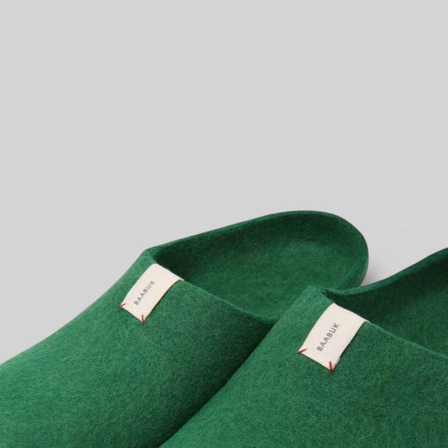 Baabuk Kanga lush green wool slippers featuring a minimalist design and a small branded tab on the side