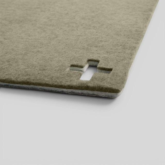 Baabuk khaki felted wool table mat with a Swiss cross cutout detail on a neutral background.