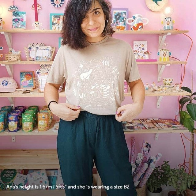 Baabuk khaki merino wool t-shirt with 10th anniversary illustration by Ana Seixas Santos, worn by a woman.