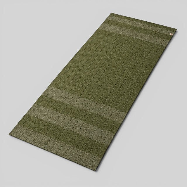 Baabuk khaki felted wool yoga mat with striped design and cotton stitching for a soft, natural practice surface.