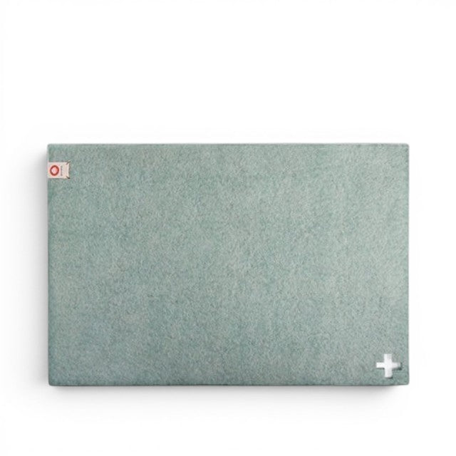 Baabuk light blue felted wool table mat with a small Swiss cross detail and brand tag.