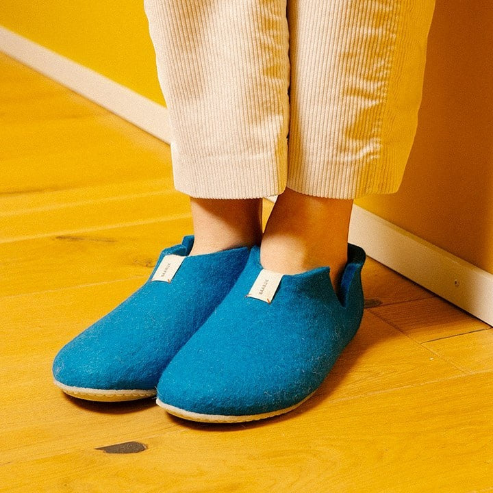 Baabuk Lisa slippers in azur blue wool with natural crepe rubber soles worn on wooden floor