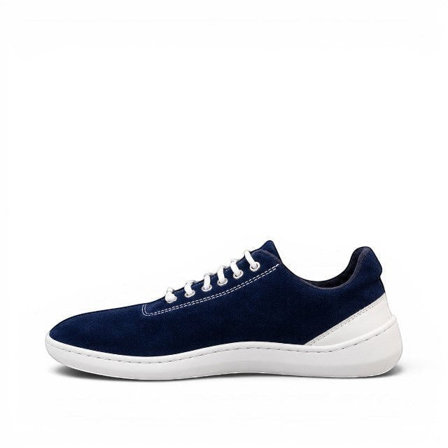 Baabuk Zero Wooler Low navy blue barefoot shoe with wool upper, white rubber sole, and cotton laces, side view.